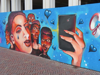 844141 Afbeelding van een graffitikunstwerk met een smartphone, op de bouwschutting aan de achterzijde van het ...